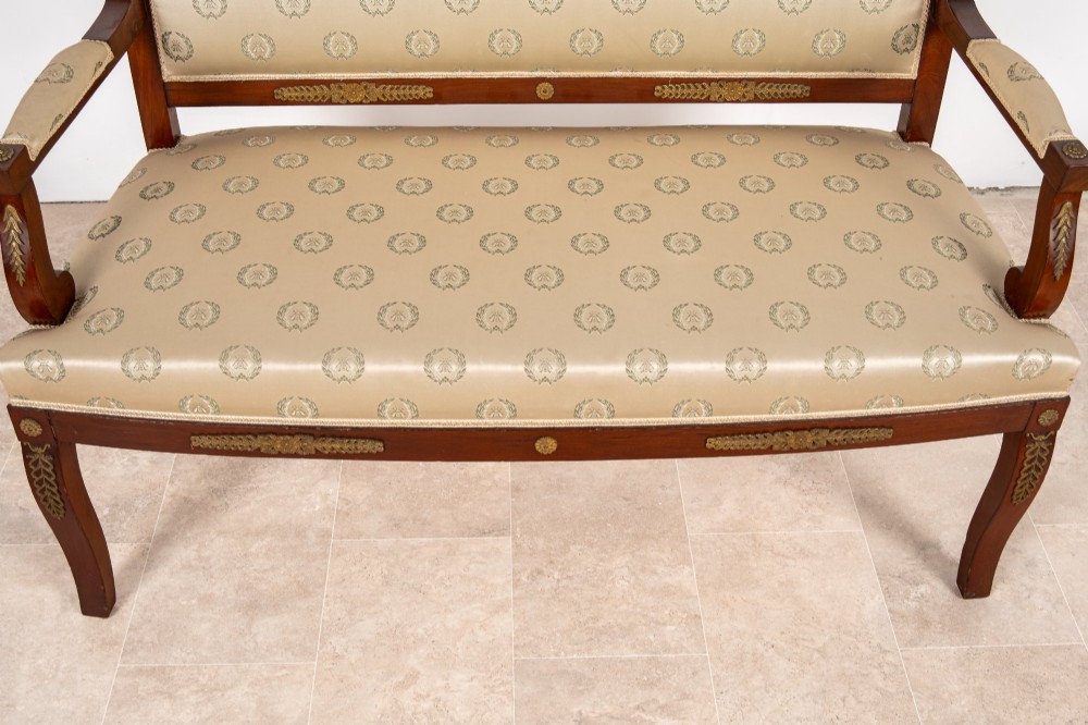 A three-piece antique French Empire Revival salon suite comprising a mahogany two-seater settee and two matching side chairs with gold silk laurel wreath upholstery and ormolu mounts. View VII