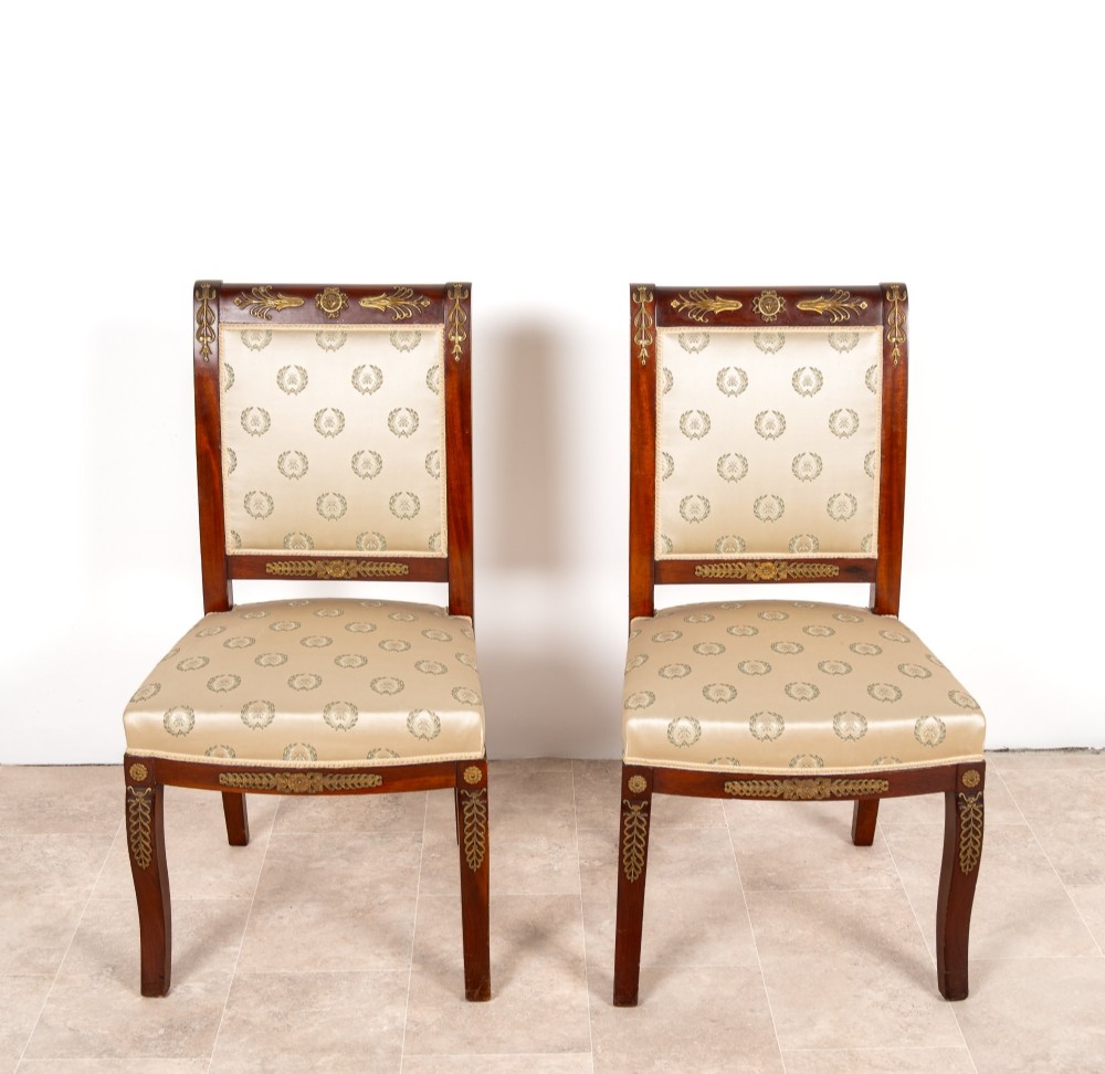 A three-piece antique French Empire Revival salon suite comprising a mahogany two-seater settee and two matching side chairs with gold silk laurel wreath upholstery and ormolu mounts. View VIII