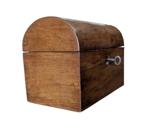 A nineteenth-century dark brown wooden tea caddy featuring a domed lid and a central keyhole. View II