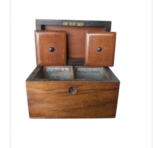 A nineteenth-century dark brown wooden tea caddy featuring a domed lid and a central keyhole. View X