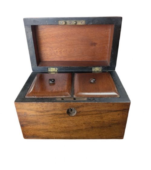 A nineteenth-century dark brown wooden tea caddy featuring a domed lid and a central keyhole. View XI