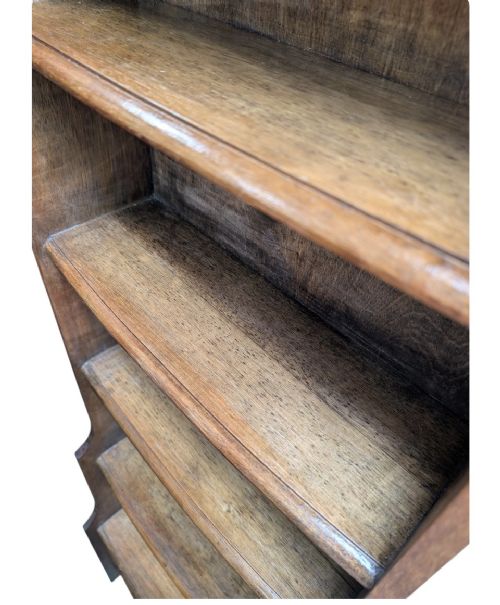 A tall, narrow warm brown oak open bookcase featuring graduated waterfall sides and seven tiers of shelving. View VIII