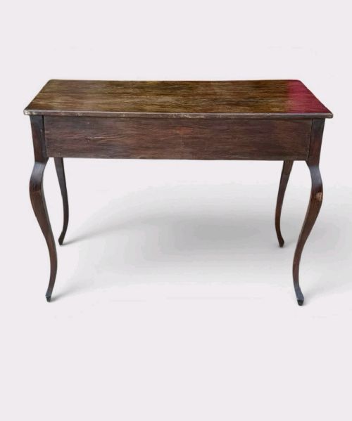 A late Victorian mahogany writing table with three drawers, brass keyhole escutcheons, and slender cabriole legs. View V