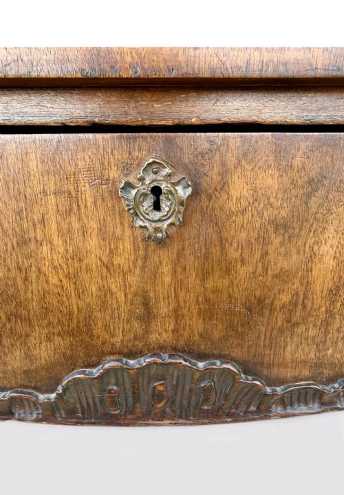 A late Victorian mahogany writing table with three drawers, brass keyhole escutcheons, and slender cabriole legs. View VII