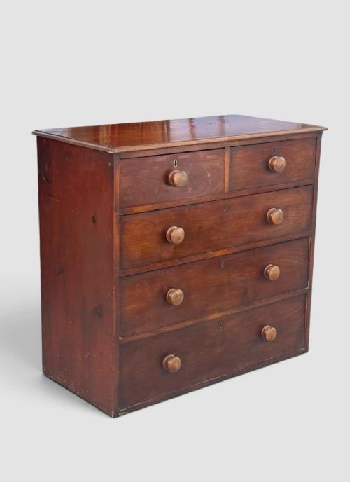fig 1. A Victorian pine chest of drawers featuring two short drawers over three long drawers with turned wooden knobs and keyholes.