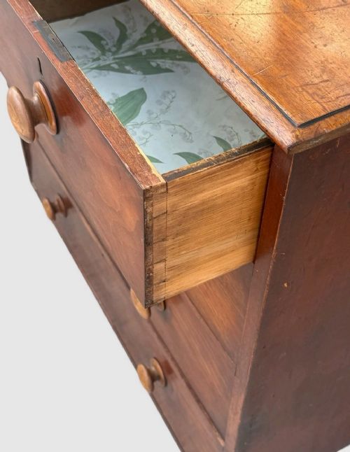 A Victorian pine chest of drawers featuring two short drawers over three long drawers with turned wooden knobs and keyholes. View VII