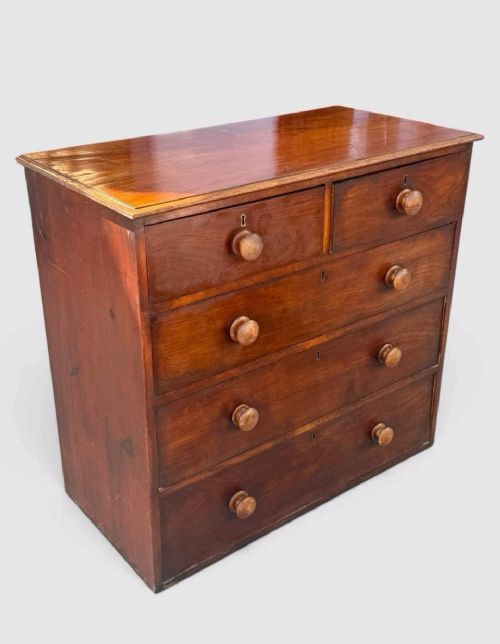 A Victorian pine chest of drawers featuring two short drawers over three long drawers with turned wooden knobs and keyholes. View IX