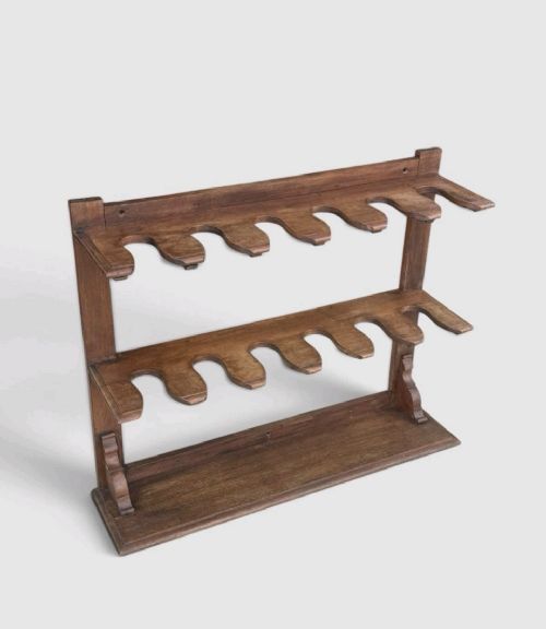 fig 1. An antique Victorian mahogany boot rack featuring two tiered notched rails designed to hold footwear above a flat rectangular wooden base.