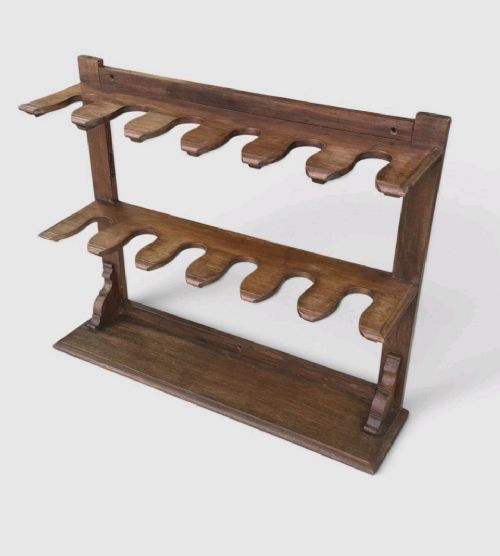 fig 2. An antique Victorian mahogany boot rack featuring two tiered notched rails designed to hold footwear above a flat rectangular wooden base.