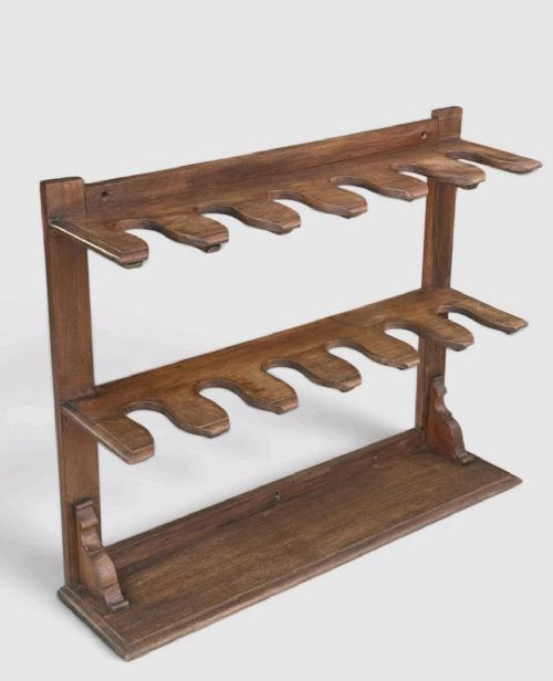 An antique Victorian mahogany boot rack featuring two tiered notched rails designed to hold footwear above a flat rectangular wooden base. View V