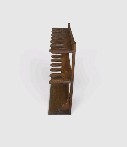 An antique Victorian mahogany boot rack featuring two tiered notched rails designed to hold footwear above a flat rectangular wooden base. View VII