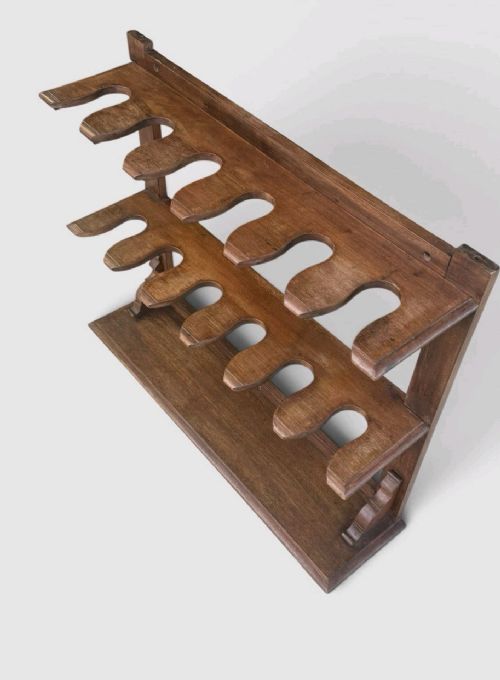 An antique Victorian mahogany boot rack featuring two tiered notched rails designed to hold footwear above a flat rectangular wooden base. View X