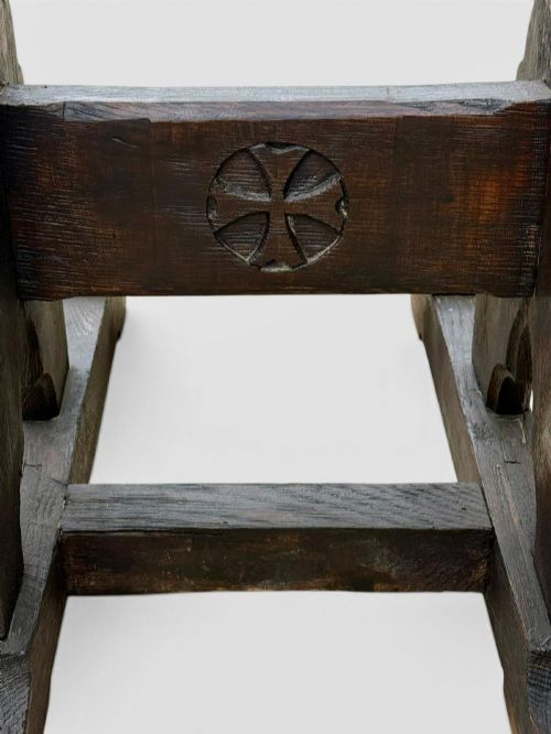 fig 3. A dark oak antique prayer desk featuring a slanted bookrest shelf, carved gothic side supports, and a built-in kneeling platform.
