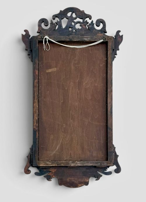 fig 2. A rectangular Georgian style dark mahogany wall mirror featuring a gilded ho-ho bird crest, gilt inner slip border, and a carved shell marquetry medallion at the base.