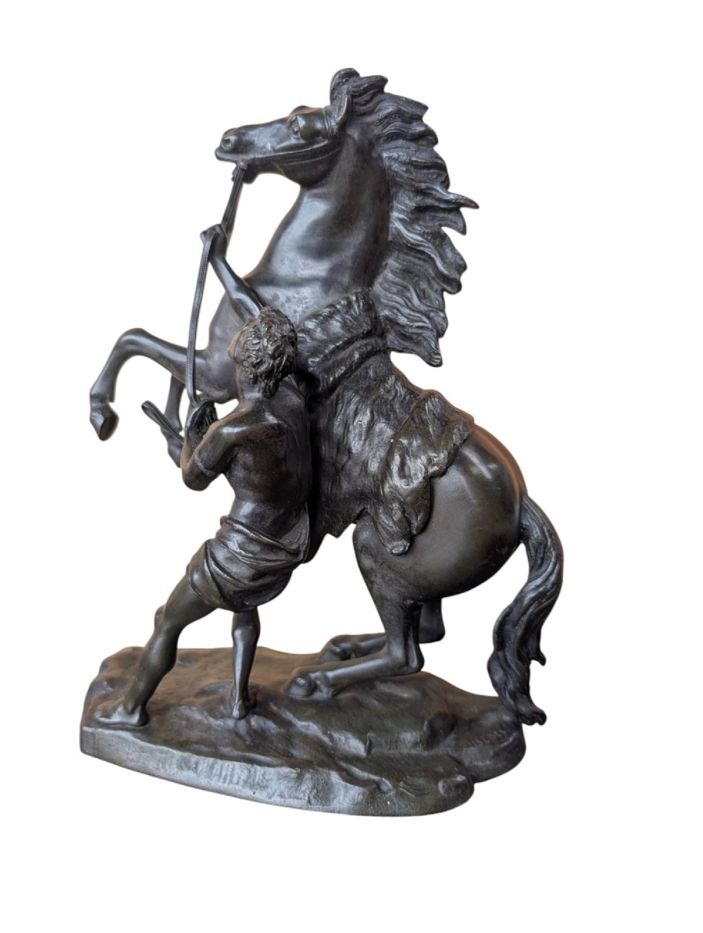A pair of dark bronze sculptures depicting rearing horses restrained by standing grooms on naturalistic rock bases. View III