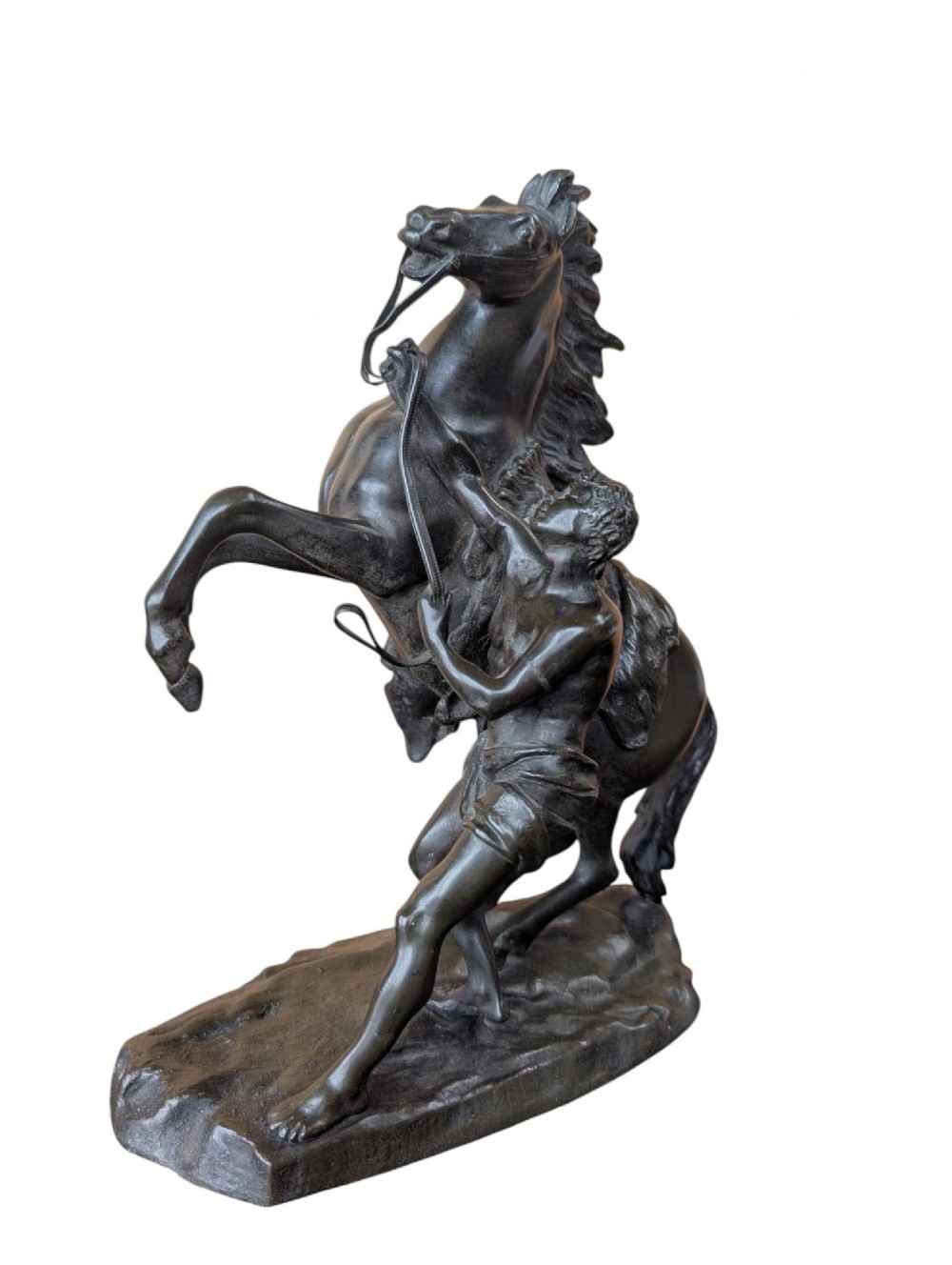 A pair of dark bronze sculptures depicting rearing horses restrained by standing grooms on naturalistic rock bases. View IV