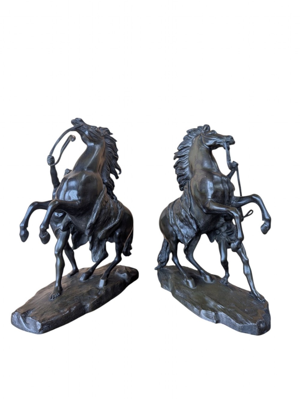 A pair of dark bronze sculptures depicting rearing horses restrained by standing grooms on naturalistic rock bases. View VI