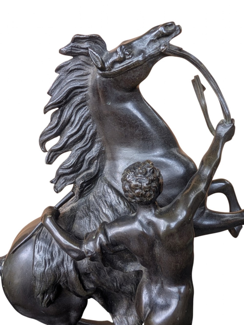 A pair of dark bronze sculptures depicting rearing horses restrained by standing grooms on naturalistic rock bases. View IX