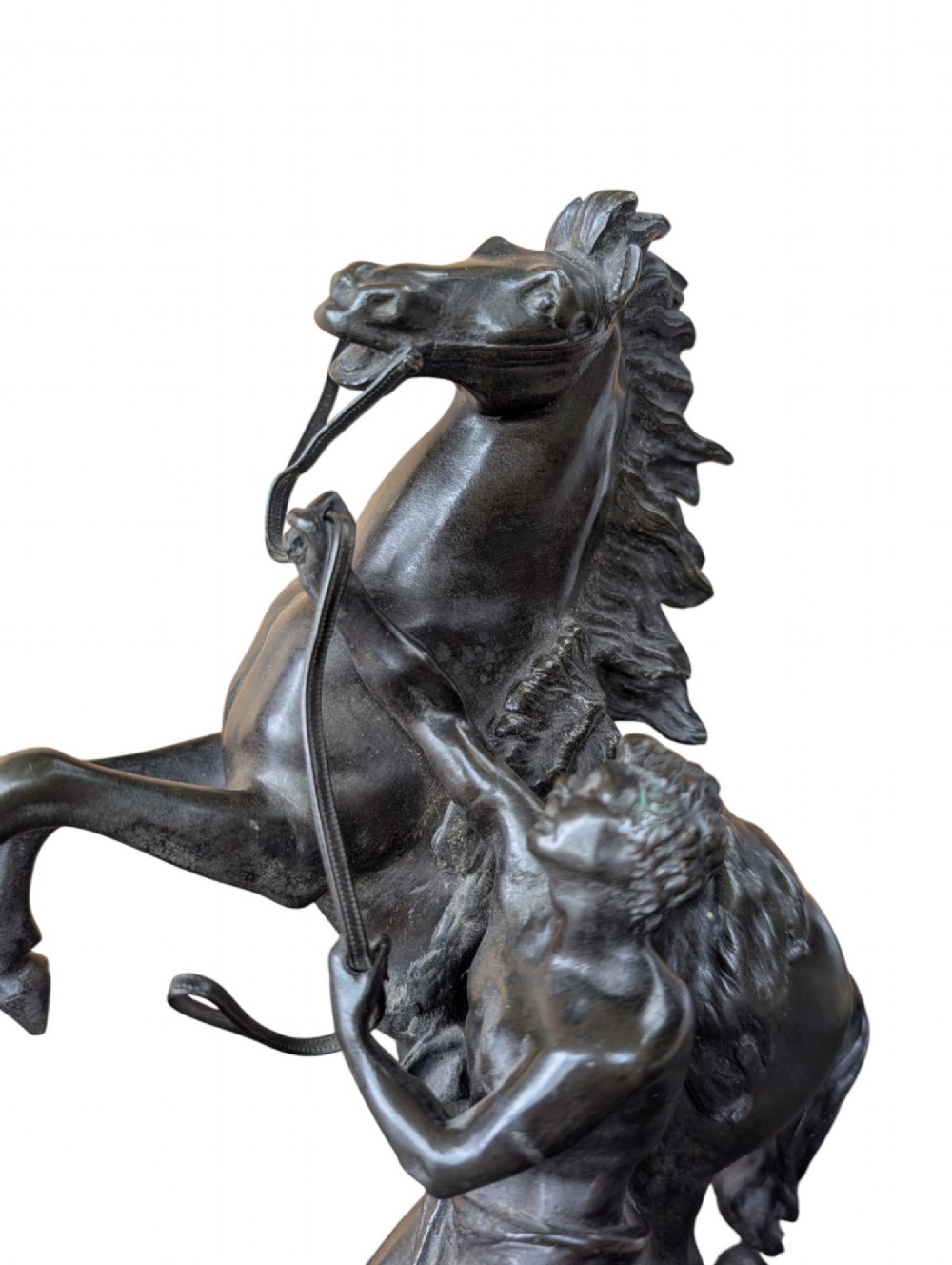 A pair of dark bronze sculptures depicting rearing horses restrained by standing grooms on naturalistic rock bases. View X