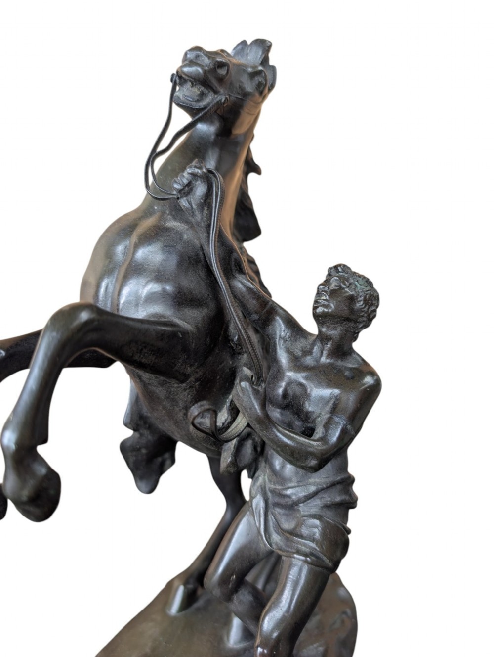 A pair of dark bronze sculptures depicting rearing horses restrained by standing grooms on naturalistic rock bases. View XI