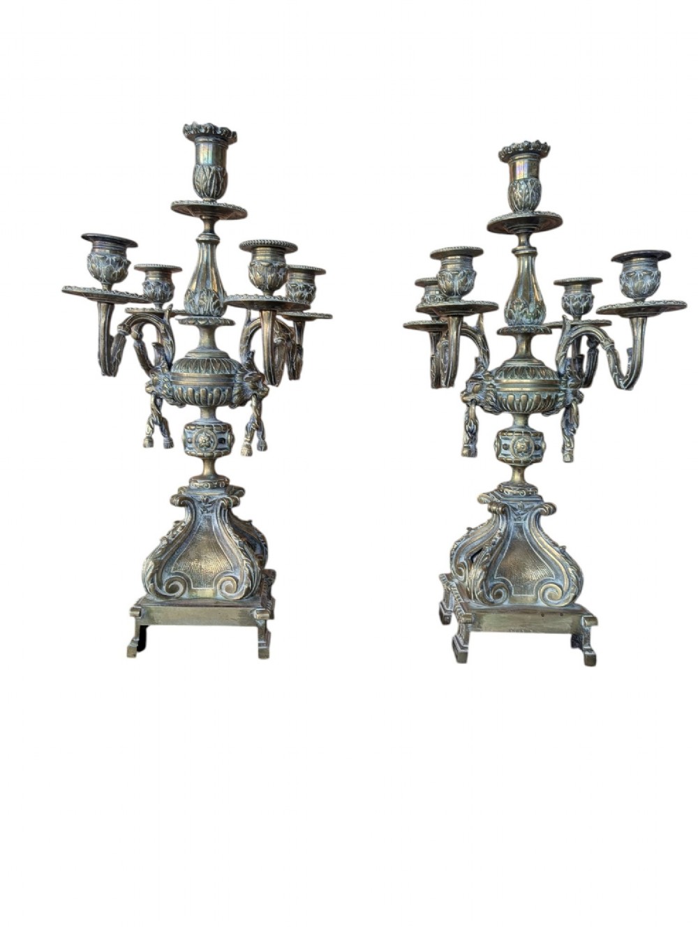 A matching pair of ornate late 19th-century patinated bronze five-light candelabra featuring lion mask motifs, scrollwork arms, and pierced decorative bases. View II