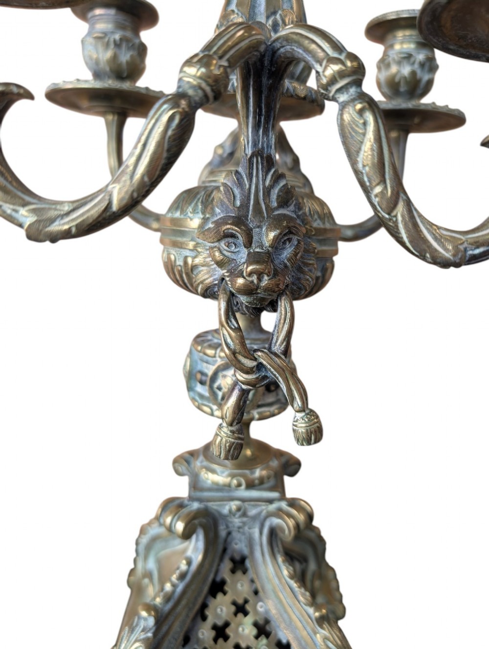 A matching pair of ornate late 19th-century patinated bronze five-light candelabra featuring lion mask motifs, scrollwork arms, and pierced decorative bases. View V