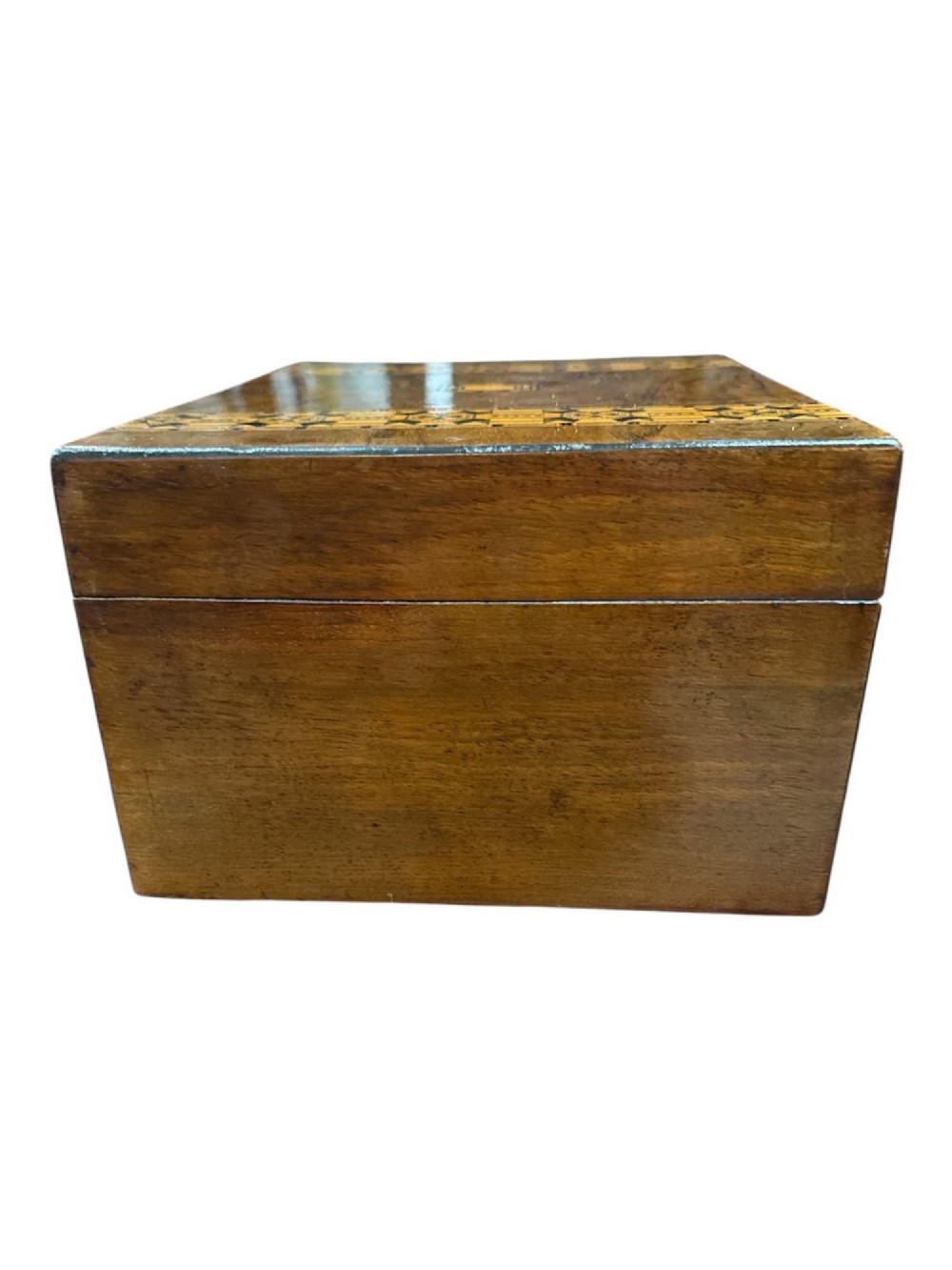 An open antique Victorian wooden sewing box featuring geometric Tunbridge ware mosaic inlay and a red ruched silk interior with removable tray compartments. View III