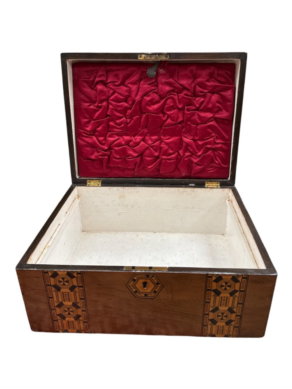 An open antique Victorian wooden sewing box featuring geometric Tunbridge ware mosaic inlay and a red ruched silk interior with removable tray compartments. View VI