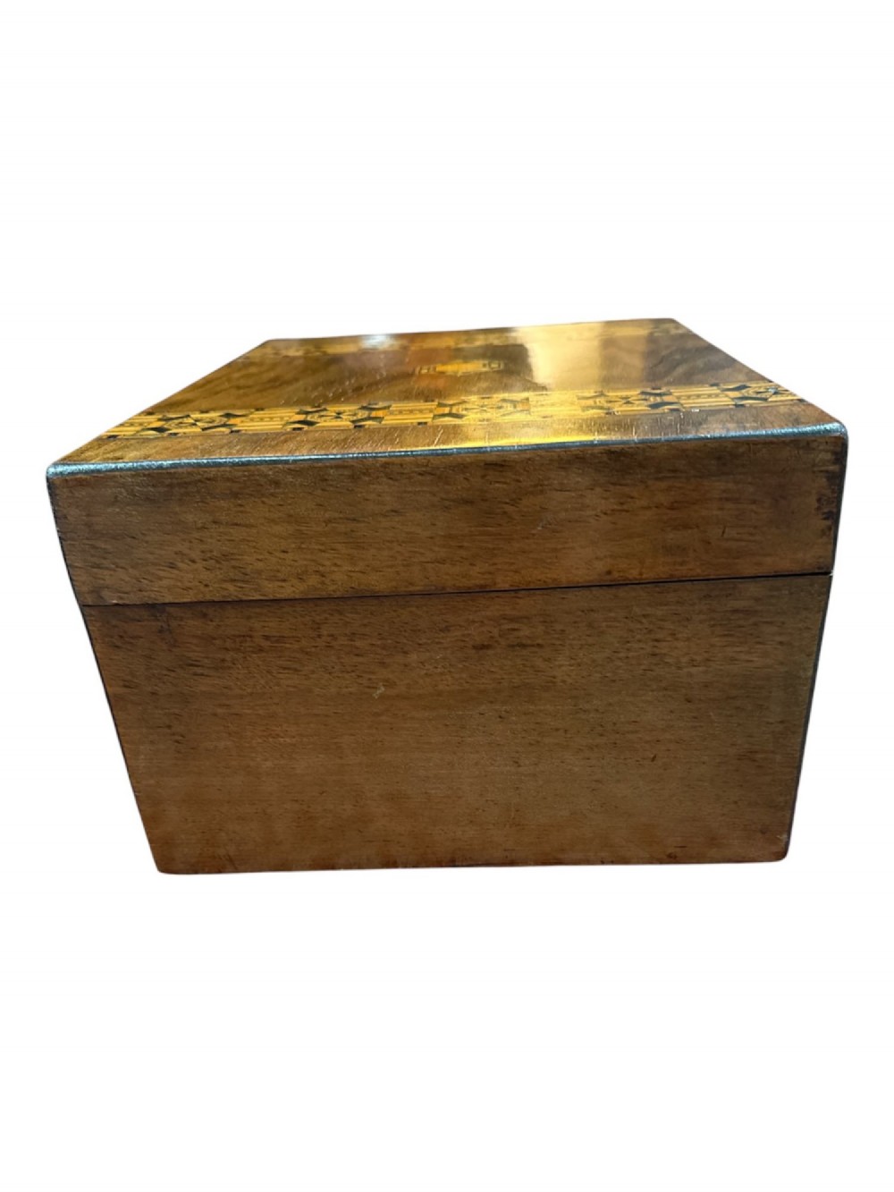 An open antique Victorian wooden sewing box featuring geometric Tunbridge ware mosaic inlay and a red ruched silk interior with removable tray compartments. View VII