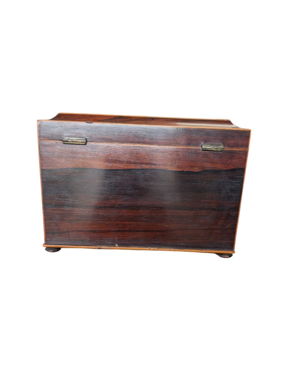 A rectangular Regency period wooden tea caddy featuring dark wood grain, mosaic inlay borders, and a central diamond escutcheon. View III