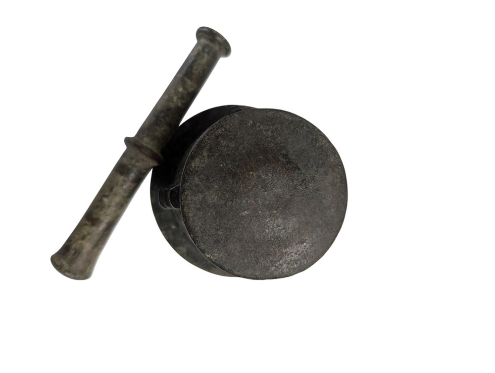An antique cast bronze mortar and pestle displaying an aged surface patina with a flared rim and turned central ridge. View VI