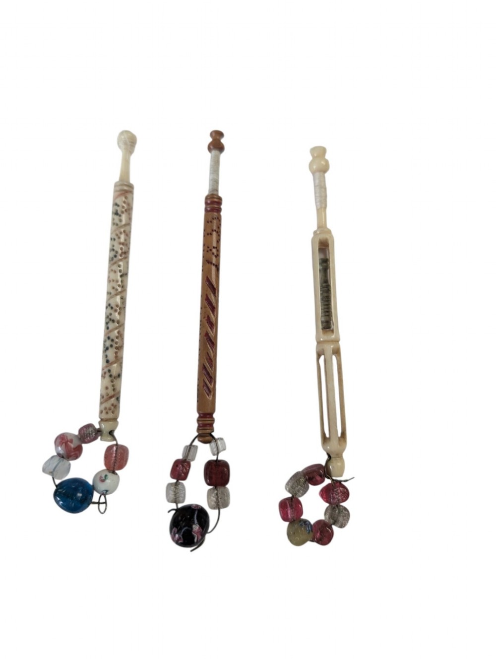 Three turned antique lace bobbins crafted from bone and wood, each featuring decorative wire-bound glass bead spangles.