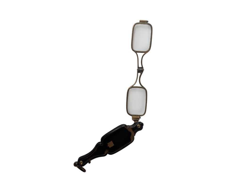 A French antique folding lorgnette with a faux tortoiseshell protective case and brass-framed rectangular lenses extended.