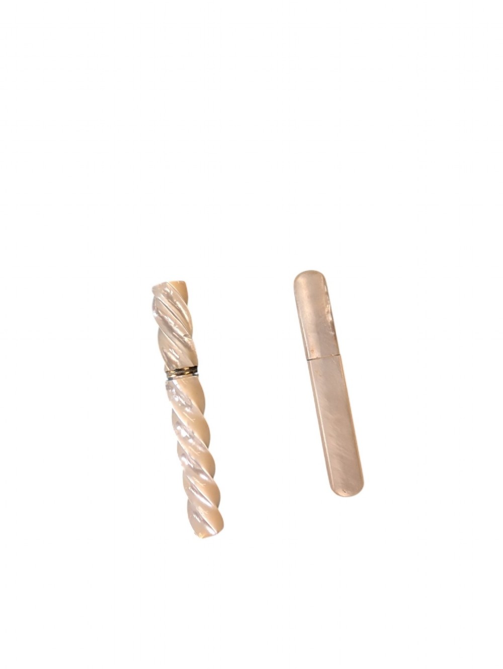 Two 19th-century mother-of-pearl needle cases, one featuring a carved spiral design and the other a smooth rectangular shape with rounded ends.