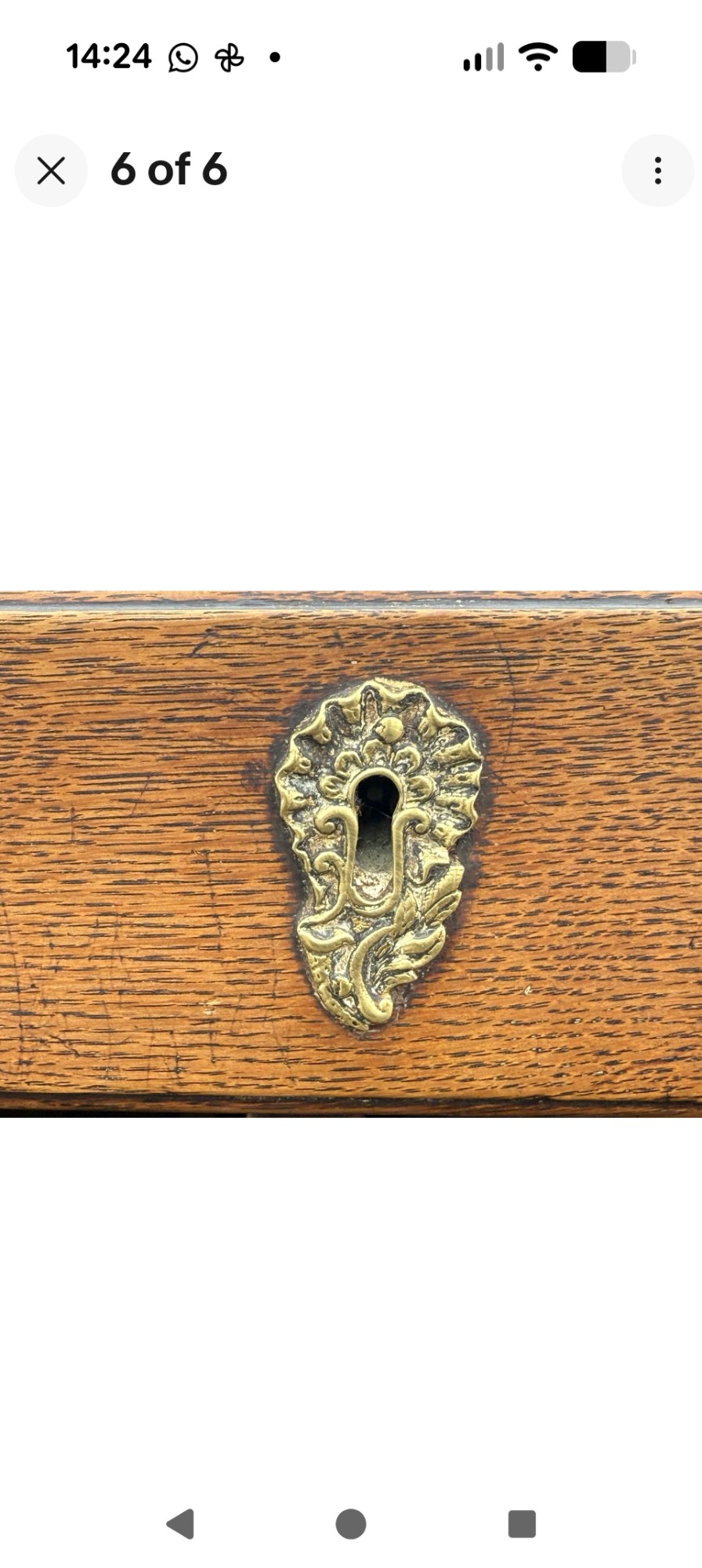 An 18th-century Georgian oak lowboy table featuring one wide upper drawer, two lower drawers, decorative brass handles, and a shaped apron. View VI