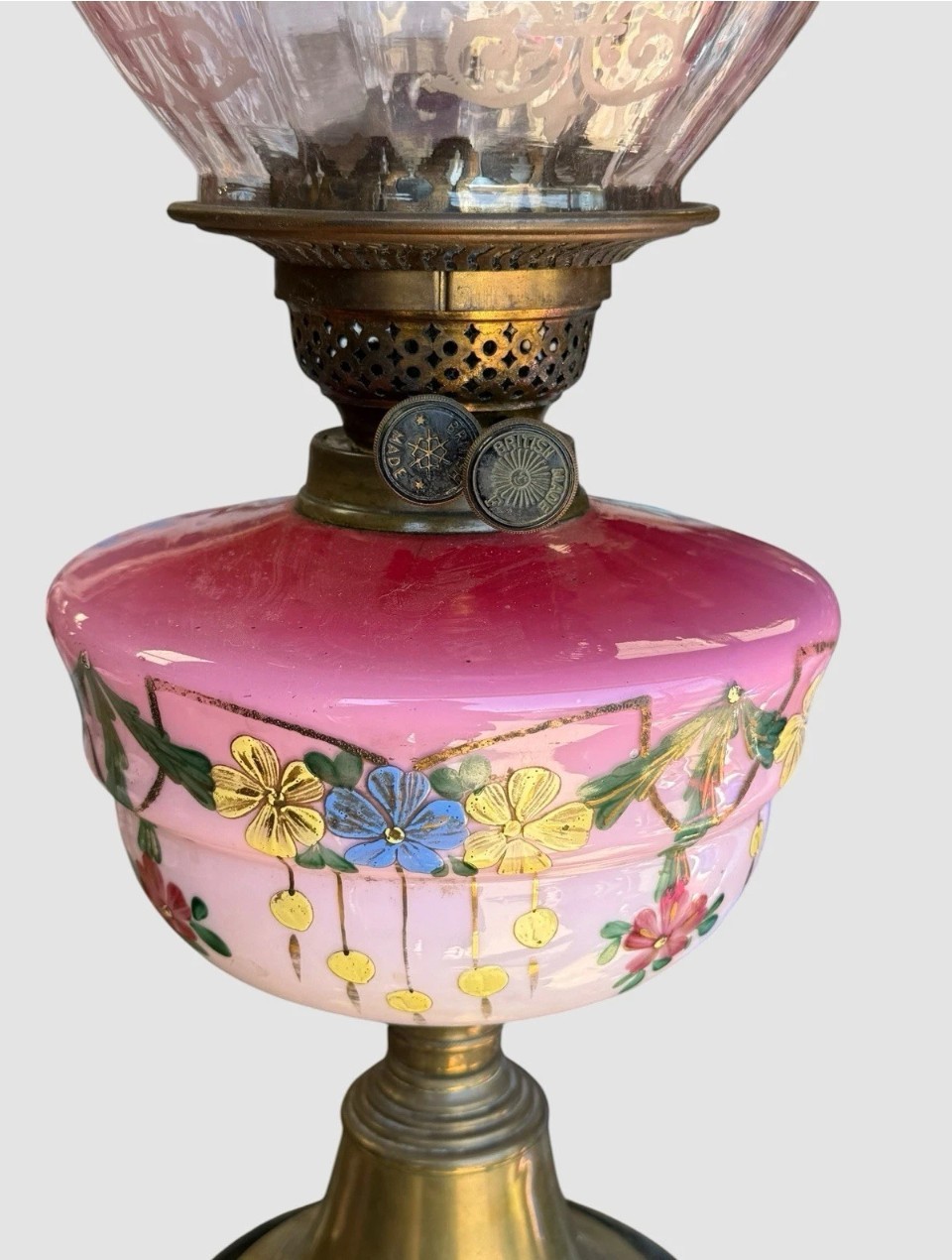 A Victorian cranberry glass oil lamp with a ruffled etched shade, hand-painted floral reservoir, brass burner, and stepped black base. View III