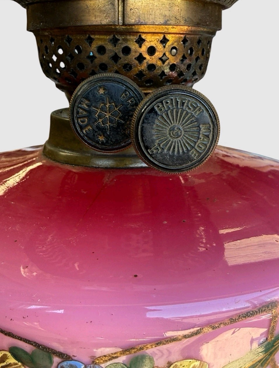 A Victorian cranberry glass oil lamp with a ruffled etched shade, hand-painted floral reservoir, brass burner, and stepped black base. View V