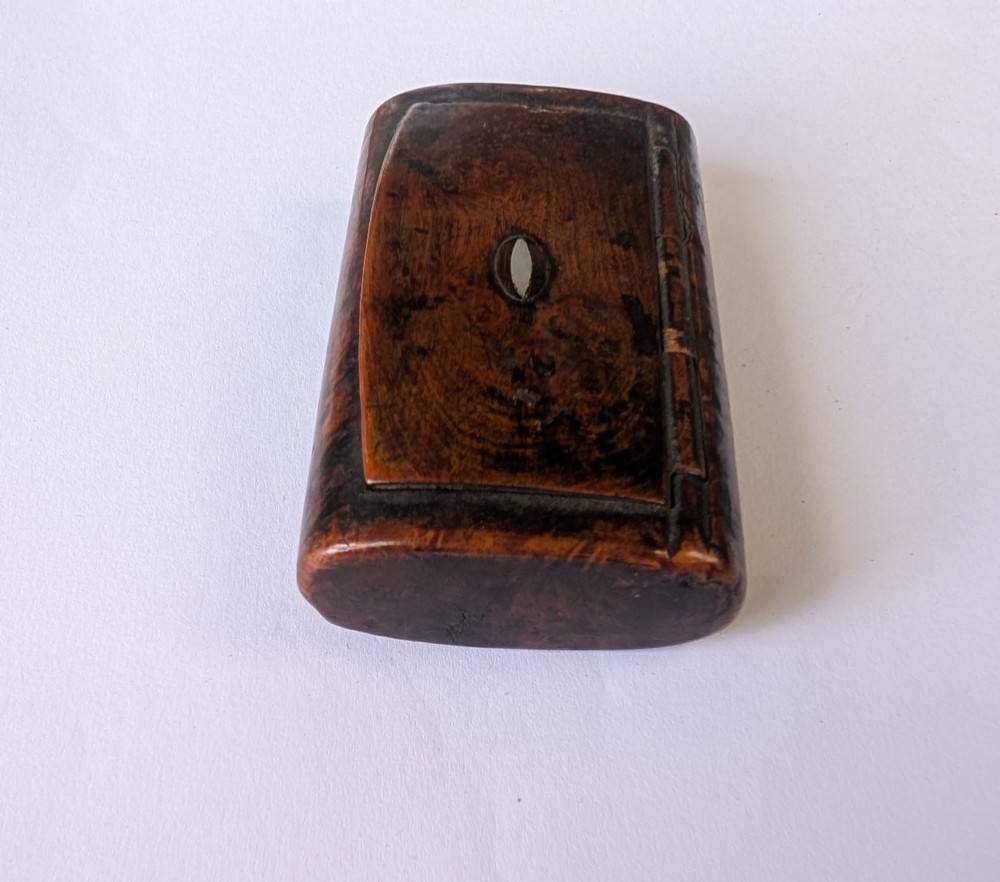 A 19th-century rectangular dark burr wood snuff box with an oval centre inlay and integrated wooden hinges. View V