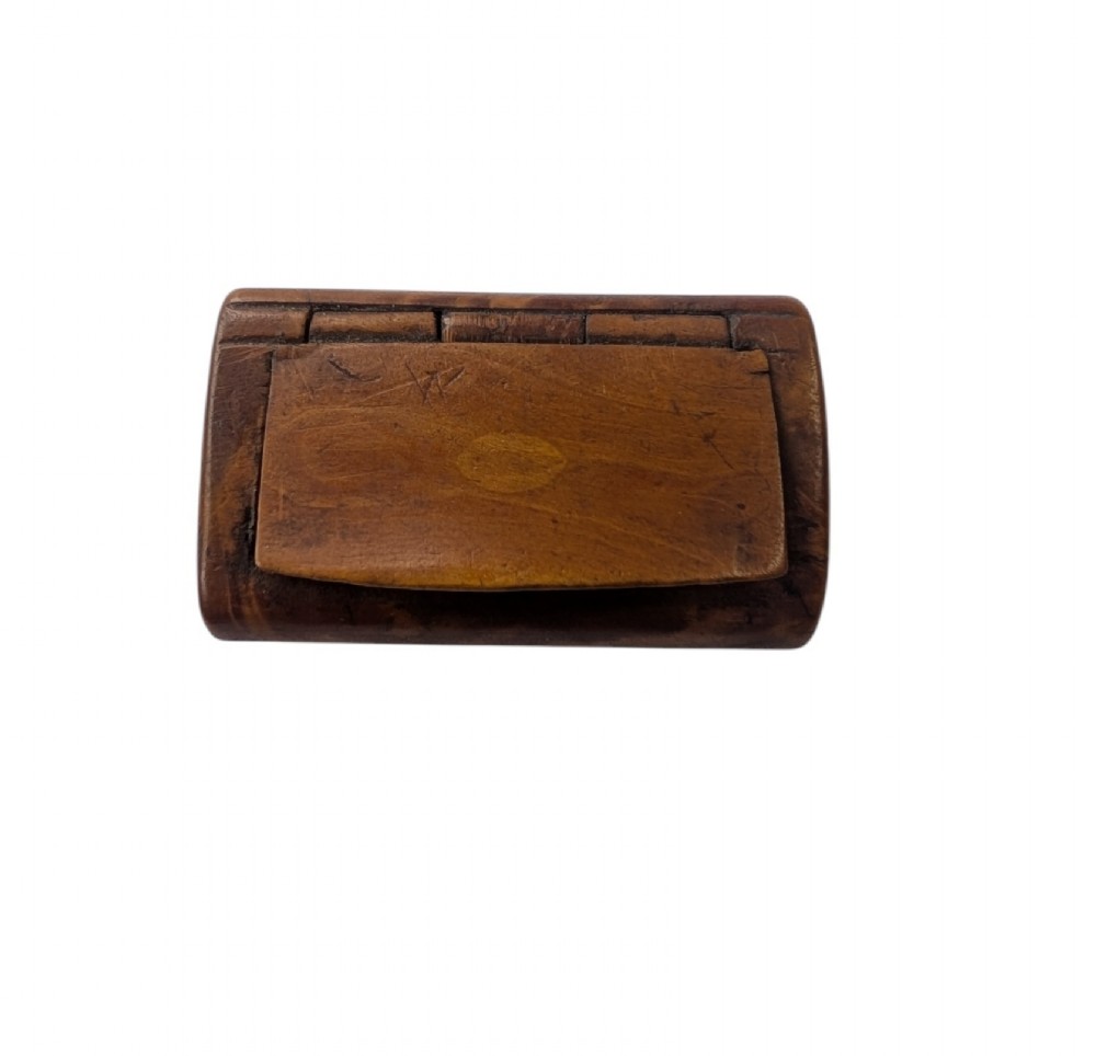 A small rectangular 19th-century carved wooden snuff box featuring an integral wooden hinge and a central oval wood inlay.