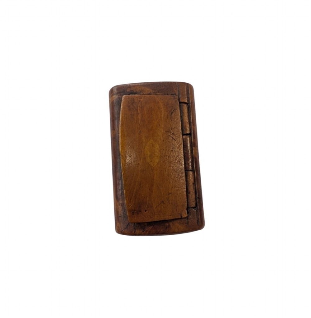 A small rectangular 19th-century carved wooden snuff box featuring an integral wooden hinge and a central oval wood inlay. View II