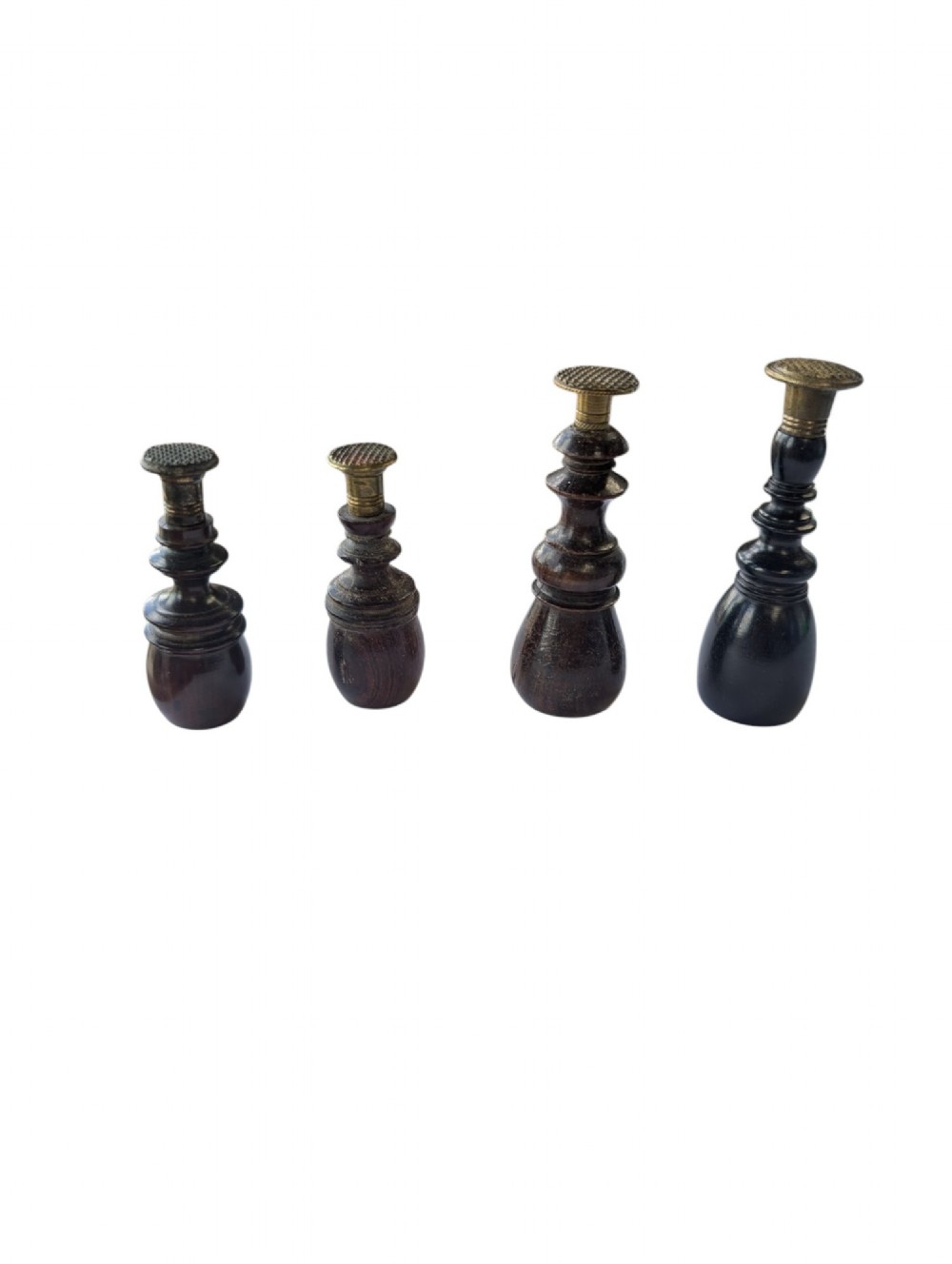 A set of four antique turned wooden wax seals featuring baluster handles and textured brass matrix heads. View II