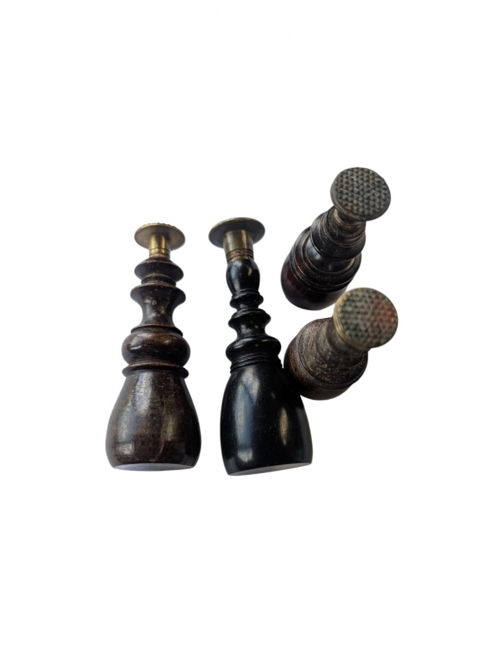 A set of four antique turned wooden wax seals featuring baluster handles and textured brass matrix heads. View III