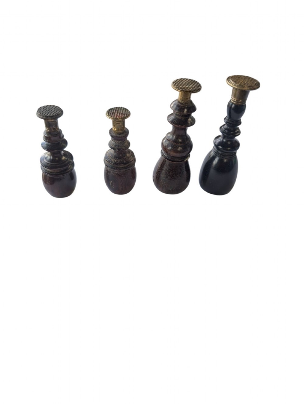 A set of four antique turned wooden wax seals featuring baluster handles and textured brass matrix heads. View IV