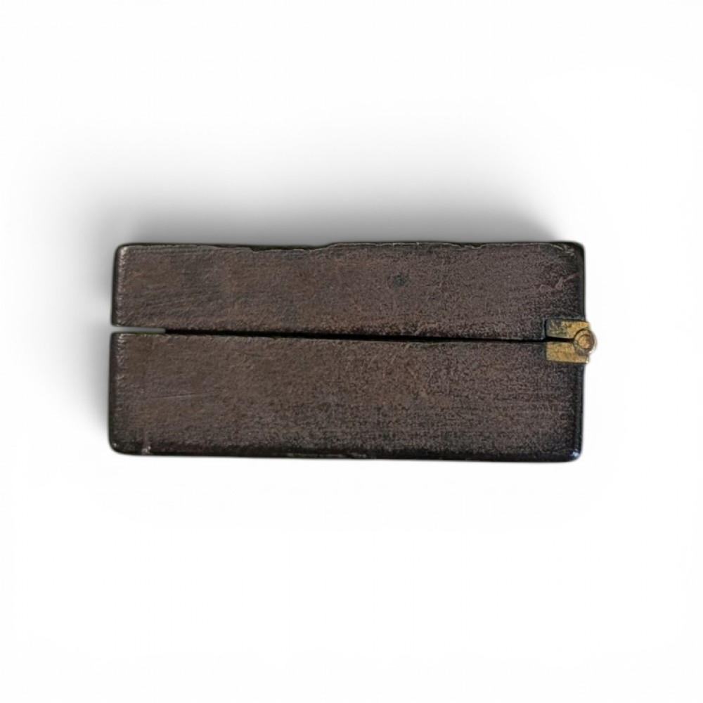 A rectangular 19th-century dark brown rhinoceros hide snuff box featuring an ornate gilt metal central cartouche and matching clasp. View III