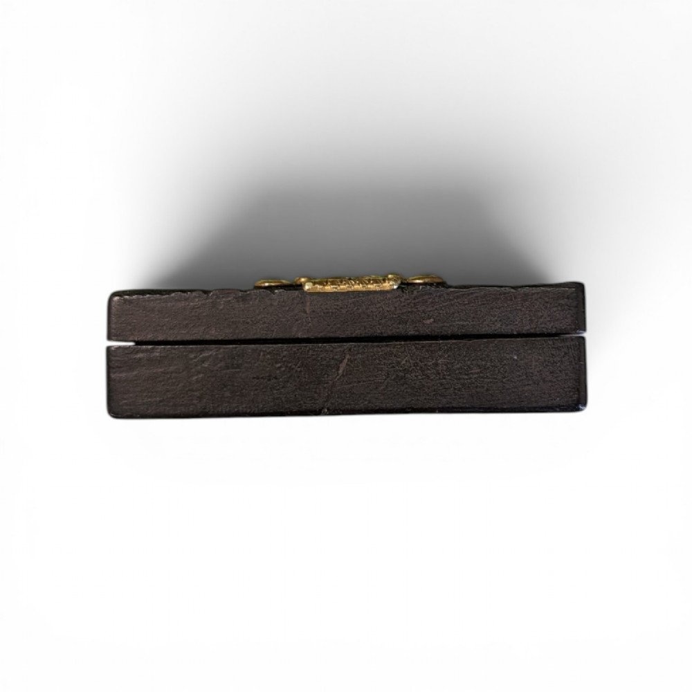 A rectangular 19th-century dark brown rhinoceros hide snuff box featuring an ornate gilt metal central cartouche and matching clasp. View IV