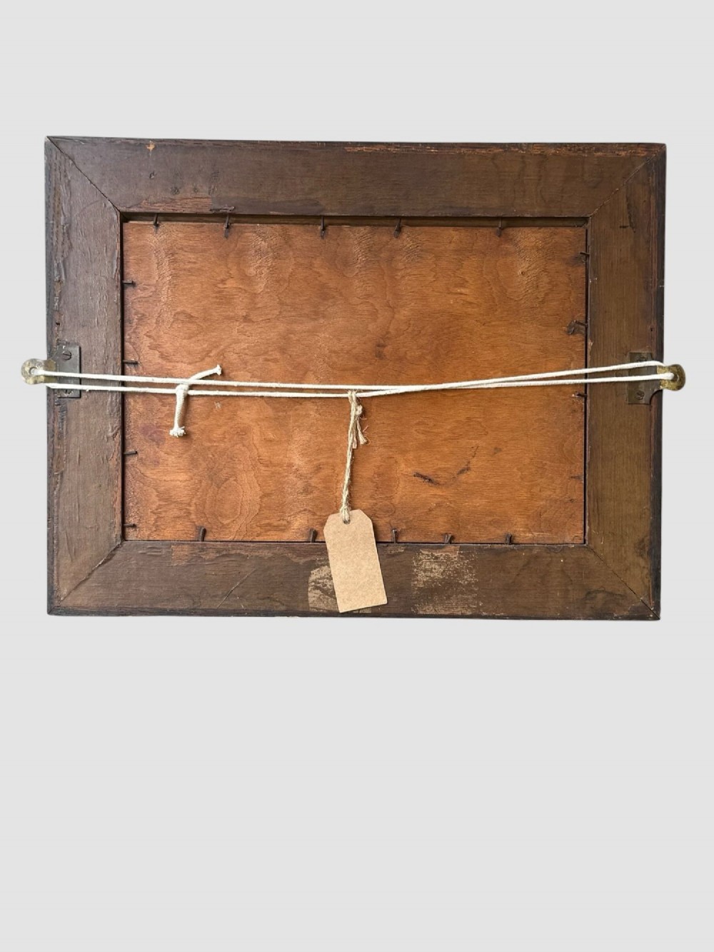 An antique dark oak framed advertising mirror featuring white script reading Bass in Bottle alongside a red triangle logo and brass Royal Warrant badges. View V