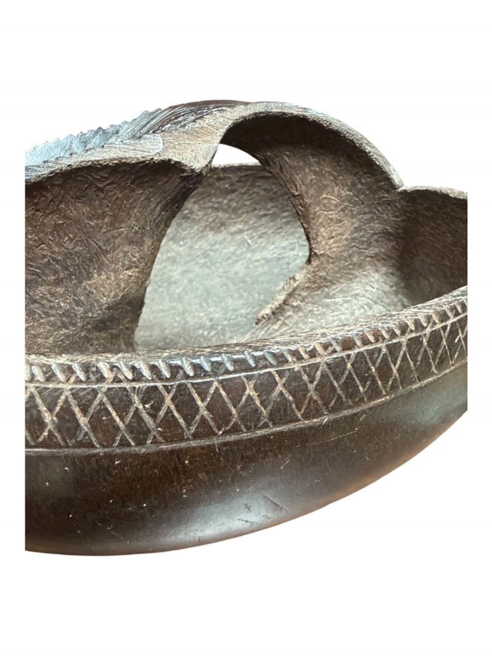 A dark brown carved Coco de Mer nut shell fashioned into a basket vessel with a central handle and incised geometric rim detailing. View V