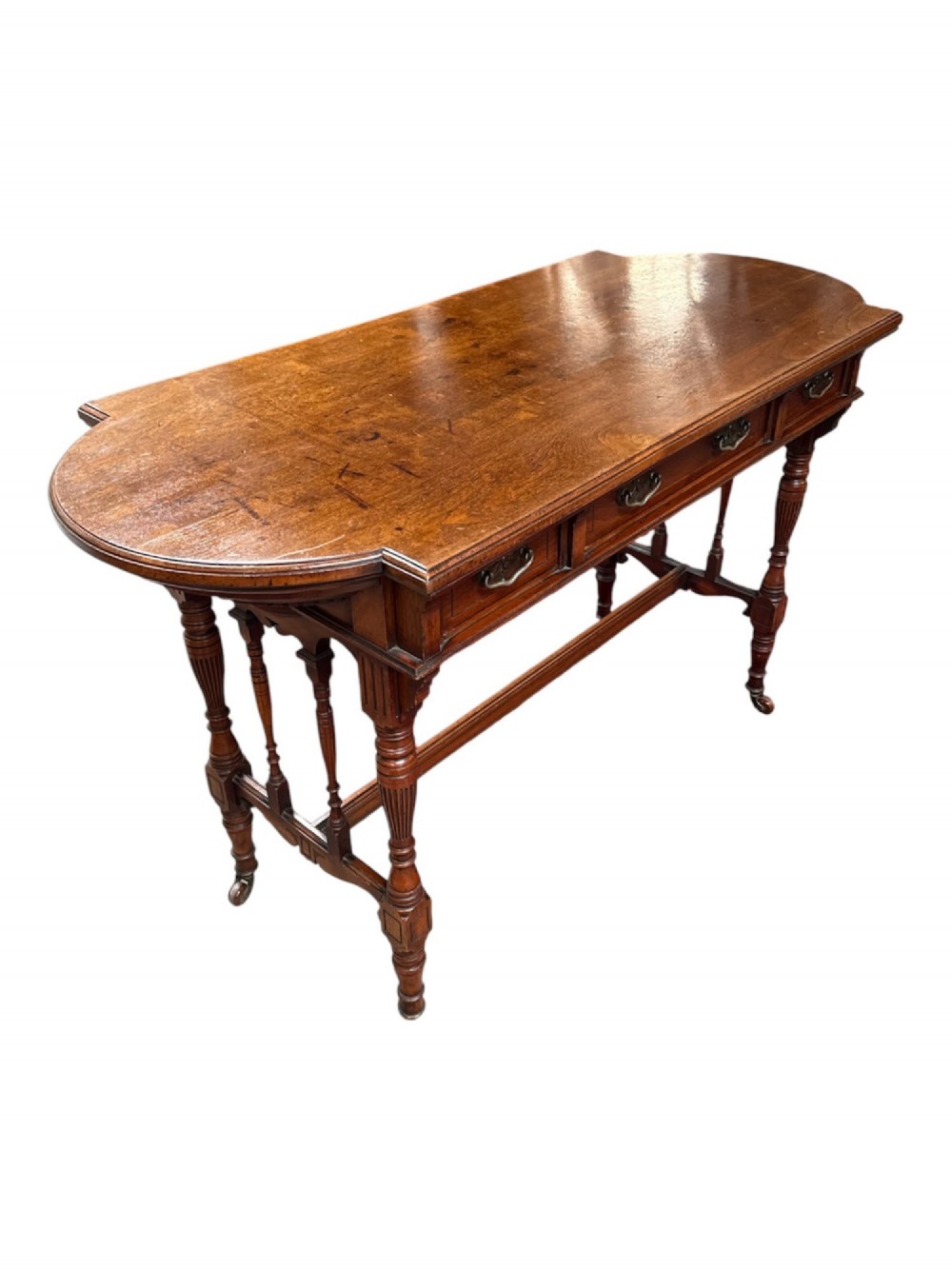 An antique warm brown oak library table featuring turned fluted legs, vertical spindle stretchers, and a polished rectangular top with rounded edges. View II