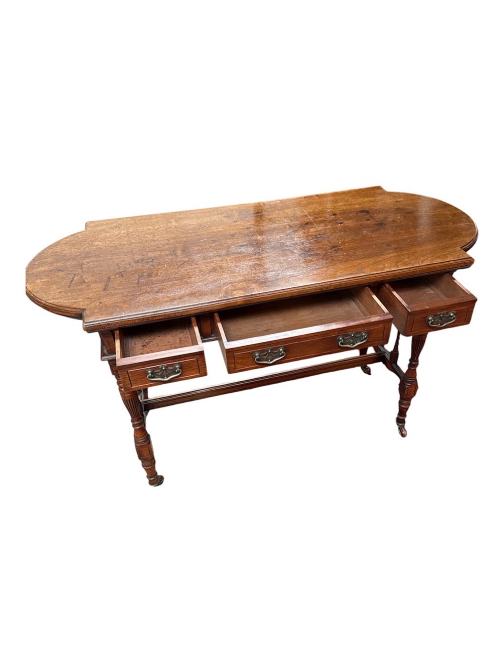 An antique warm brown oak library table featuring turned fluted legs, vertical spindle stretchers, and a polished rectangular top with rounded edges. View IV