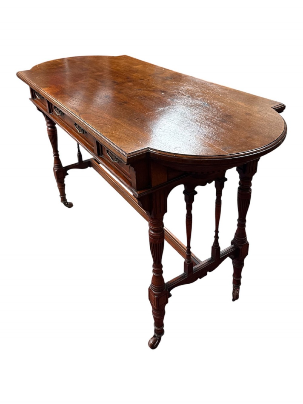 An antique warm brown oak library table featuring turned fluted legs, vertical spindle stretchers, and a polished rectangular top with rounded edges. View VI